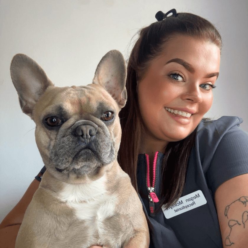 Megan McIntyre the Receptionist at Chorley Vets holding a dog